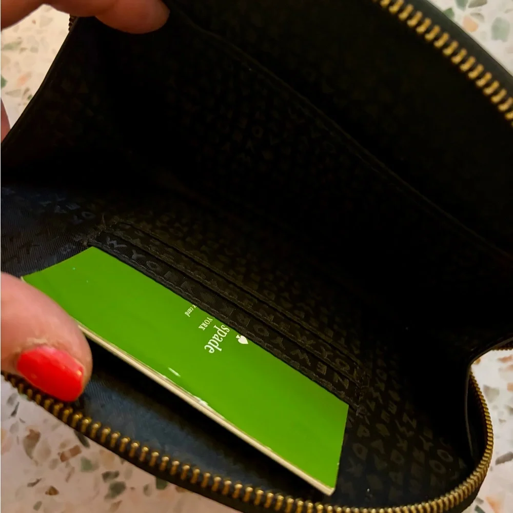 Brand new kate spade black pebble leather wristlet clutch with gold logo